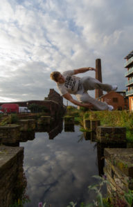 Traceur jumping between obstacles during outdoor parkour training
