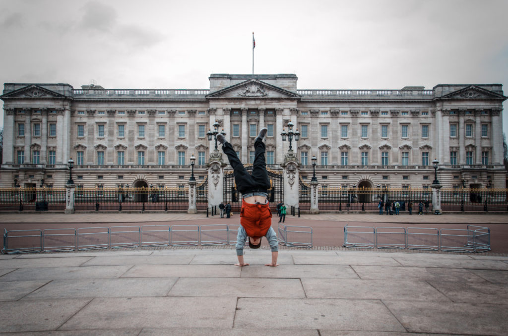 Traceur holding a handstand in an open city square