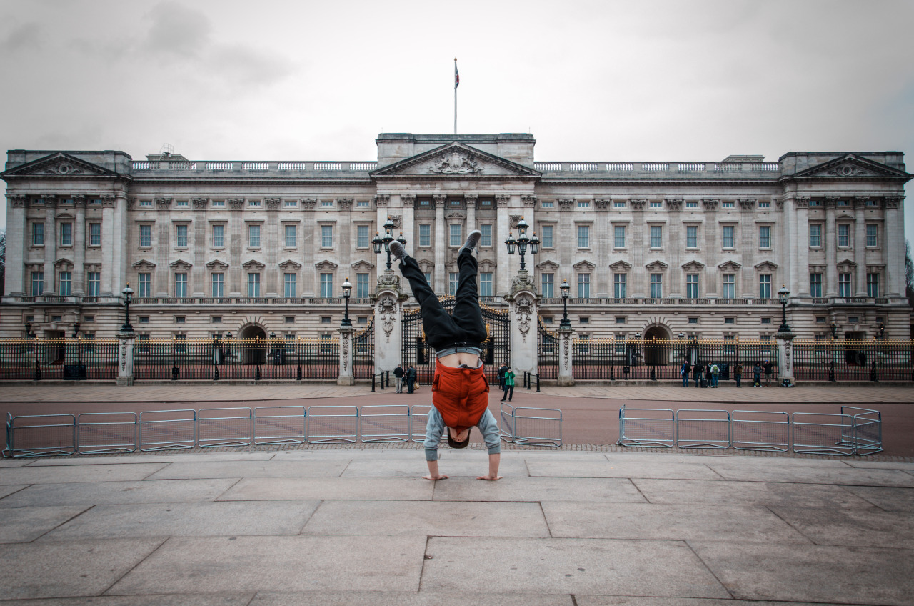 Traceur holding a handstand in an open city square