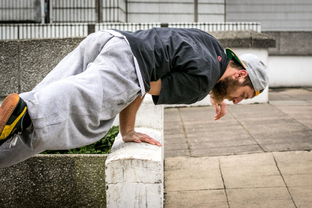 Traceur balancing low on a concrete wall