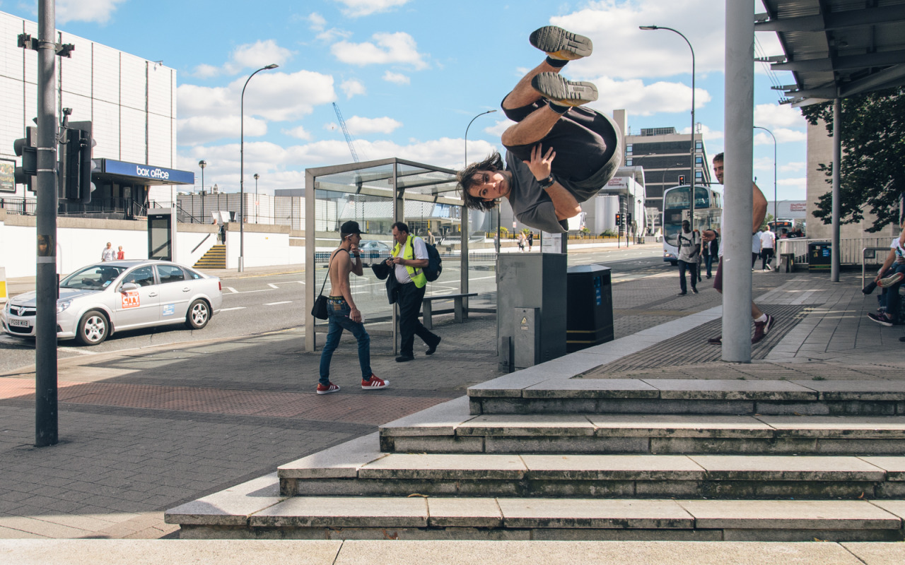 Traceur performing a jump above city-centre steps